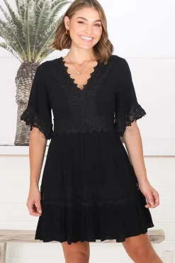 Leelie Mini Dress - Lace Embellished Tiered Dress with Bell Sleeves in Black><noscript><img width=