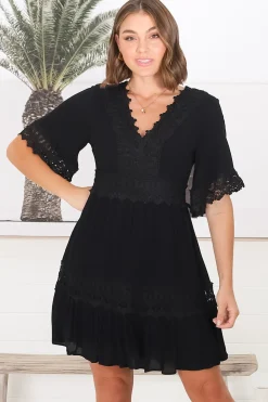 Leelie Mini Dress - Lace Embellished Tiered Dress with Bell Sleeves in Black><noscript><img width=
